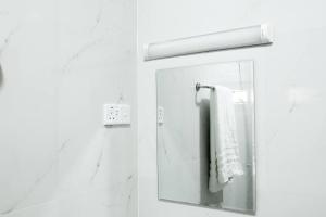 a bathroom with a mirror and a towel at Lone Star Residence in Jaffna
