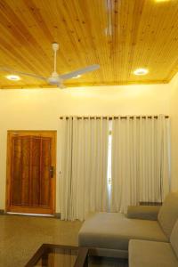a living room with a couch and a ceiling fan at Lone Star Residence in Jaffna