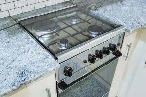 a stove top oven sitting in a kitchen at Lone Star Residence in Jaffna