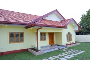a small house with a red roof at Lone Star Residence in Jaffna