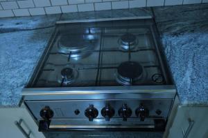 a stove top oven sitting in a kitchen at Lone Star Residence in Jaffna