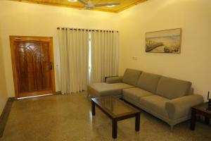 a living room with a couch and a coffee table at Lone Star Residence in Jaffna