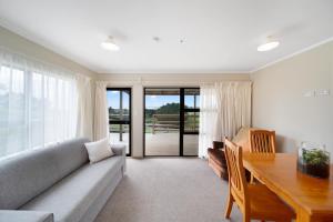 a living room with a couch and a wooden table at Apartment 4 in Auckland +21 photos