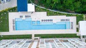 an overhead view of a building with a swimming pool at Fortunity Beach Tower-2 BDR with pool view in San Felipe de Puerto Plata