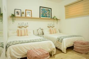 two beds in a room with at Fortunity Beach Tower-2 BDR with pool view in San Felipe de Puerto Plata