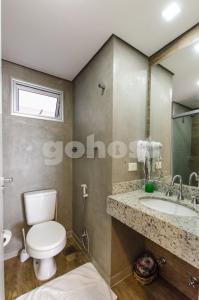 y baño con aseo y lavamanos. en Comfortable Villa Morra Loft, en Asunción