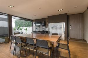 a kitchen and dining room with a wooden table and chairs at Exclusive And Luxurious Penthouse In Herrera in Asunción
