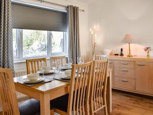 a dining room with a table and chairs and a window at Glebeside Retreat in Satley