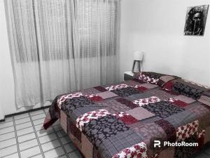 1 dormitorio con 1 cama con edredón en SANBERJERE en San Bernardo