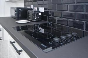 a counter with a coffee maker and a microwave at The Green House in Stoke on Trent