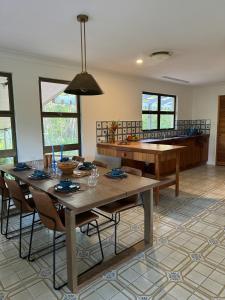 a kitchen with a table and chairs in a room at Amongst the Trees in Mooloolah