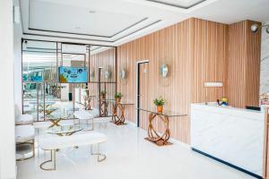 a salon with tables and chairs in a room at Hotel Ariandri Puncak in Puncak