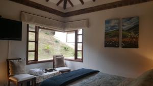 a bedroom with a bed and a window at Casa Hotel San Pedro in Villa de Leyva