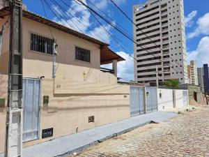 a building on the side of a street with a tall building at Casa em Ponta Negra in Natal