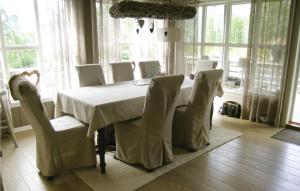 a dining room table with chairs and a white table cloth at Awesome Home In Stranda With Wifi in Stranda