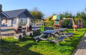 a park with a picnic table and a playground at Awesome Home In Ustronie Morskie With Kitchen in Ustronie Morskie