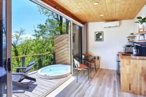 a kitchen with a balcony with a hot tub at The Glamping Collective in Clyde