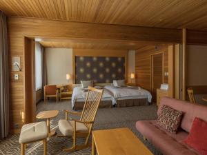 a hotel room with a bed and a couch at Shigakogen Prince Hotel in Yamanouchi