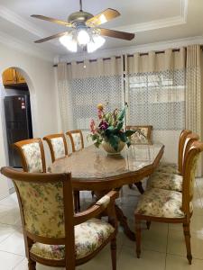 a dining room table with chairs and a ceiling fan at Ipoh Center Elegant Bungalow Near to Sunway in Ipoh