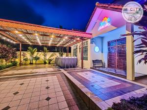 a home with a lit up patio at night at JB Town Villa by JBcity Home in Johor Bahru