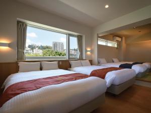 Postel nebo postele na pokoji v ubytování Private Condo Chatan Jagaru by Coldio Premium