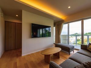 TV a/nebo společenská místnost v ubytování Private Condo Chatan Jagaru by Coldio Premium
