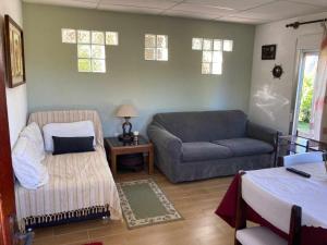 a living room with a couch and a chair at Mar 11 a 100 mtros del mar in Parque del Plata