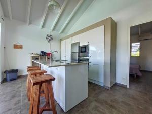 a kitchen with a counter and a stove top oven at cannelle in Sainte-Anne