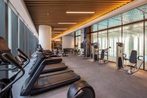 a gym with treadmills and elliptical machines at Grand Mercure Yichang Waitan in Yichang