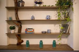 a shelf with blue and white vases and books at Hortensia Flower in Hanoi