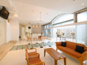 a living room with a couch and chairs at Sabae City Hotel in Sabae