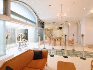 a living room with a couch and a dining room at Sabae City Hotel in Sabae