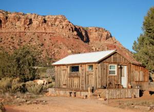 a wooden cabin with a mountain in the background at Rustic Ranch Getaway Near Zion, Bryce, Grand Canyon in Fredonia
