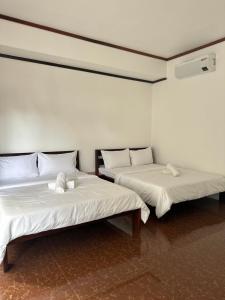 Postel nebo postele na pokoji v ubytování Haven Suites Siargao