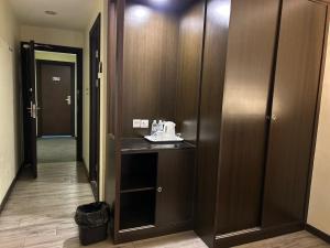 a corridor of a hotel room with a hallway with wooden doors at LUCKY - 5 INN in Bintulu +11 photos