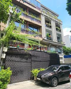 a car parked in front of a building at PJ Hotel & Apartment - Thao Dien in Ho Chi Minh City