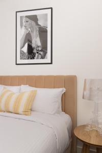 a bedroom with a bed with a picture on the wall at MAC Middle Park by Melbourne Apartment Collection in Middle Park