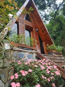 a small house with a window and pink flowers at Homestay EcoRose- Thung Lũng Hoa Hồng Điện Biên Phủ in Diện Biên Phủ