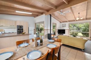 a kitchen and dining room with a table and chairs at Halls Haven Holiday Units in Halls Gap