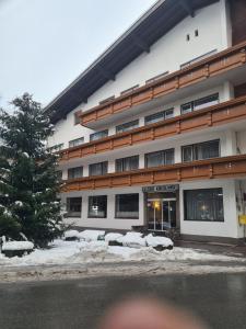 a building with snow in front of it at Gasthof Kirchenwirt in Zell am Ziller