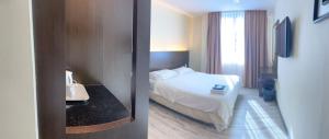 a hotel room with a bed and a window at LUCKY - 5 INN in Bintulu