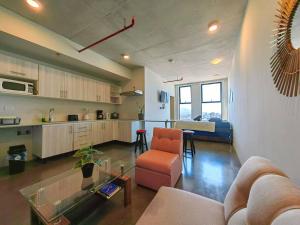 sala de estar con sofá, mesa y cocina en 906A URBN Barrio Escalante Estudio con A/C y Parqueo, en San José