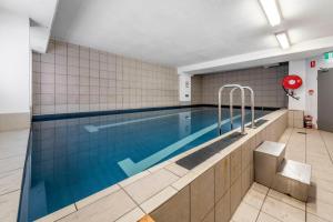 a large swimming pool in a building at Canberra City Accommodation in Canberra