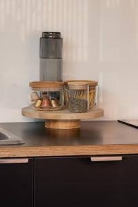 a wooden shelf with containers of food on a counter at MAC Middle Park by Melbourne Apartment Collection in Middle Park