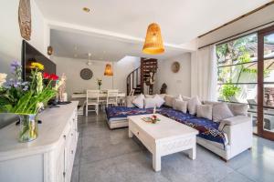 a living room with a couch and a table at Villa Bewa in Seminyak