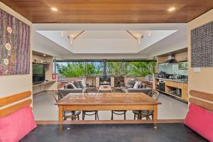 a kitchen and living room with a wooden table at Summer House in Wentworth Falls