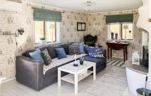 a living room with a couch and a table at Amazing Home In Köpmannebro With Wifi in Åsensbruk