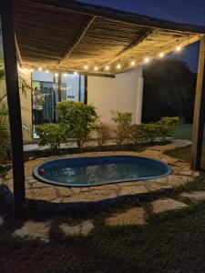 a swimming pool in a backyard with a pergola at Cabañas Casa de la Montaña in El Platanito