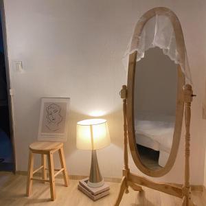 a dressing room with a mirror and a lamp and a stool at Stay Cheongnyang in Seoul