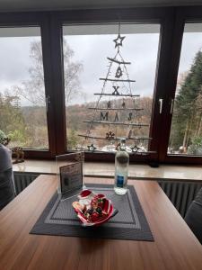 een bord eten op een tafel voor een kerstboom bij Ferienwohnungen Waldblick in Remscheid